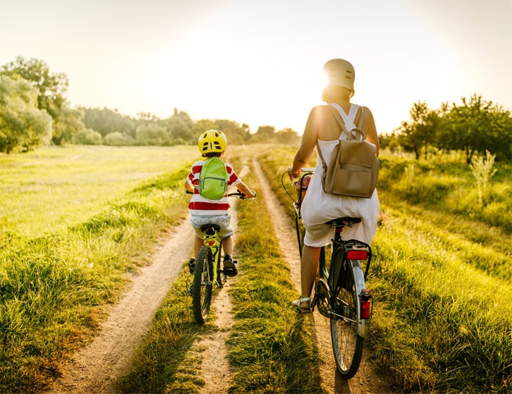 mother and son riding bikes on a the oakfield bike trails