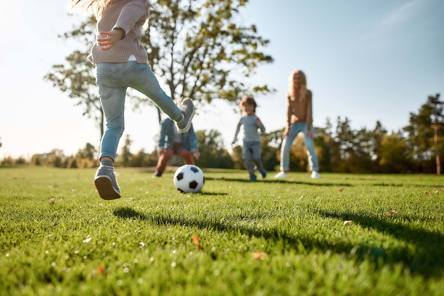 mother with 3 kids playing on the oakfield soccer fields