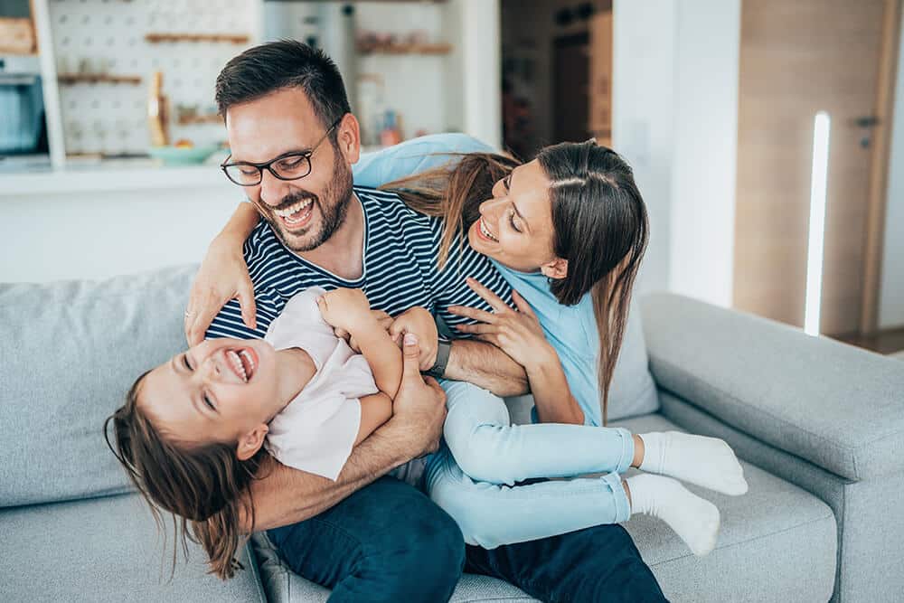 Family on couch in centex model home happy