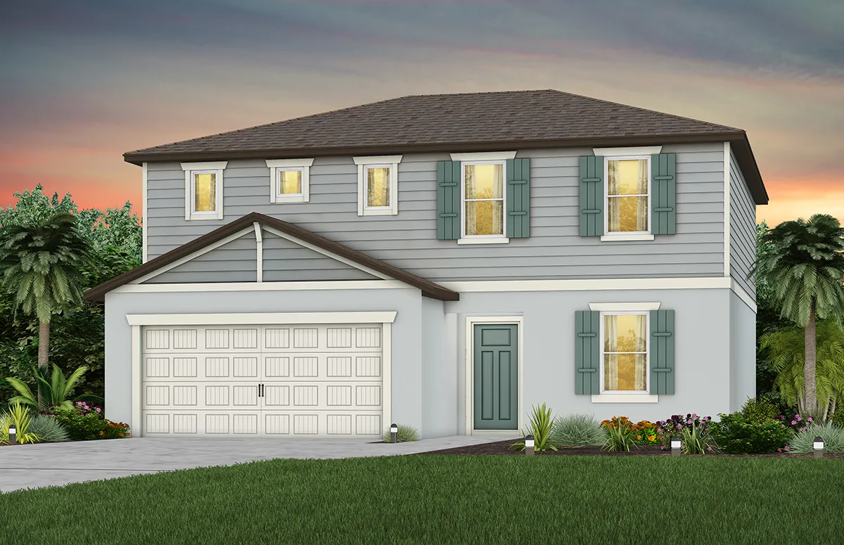 A two-story house with gray siding, white trim, green shutters, a two-car garage, and a front yard with grass and landscaping, set against a colorful sunset sky with palm trees in the background.