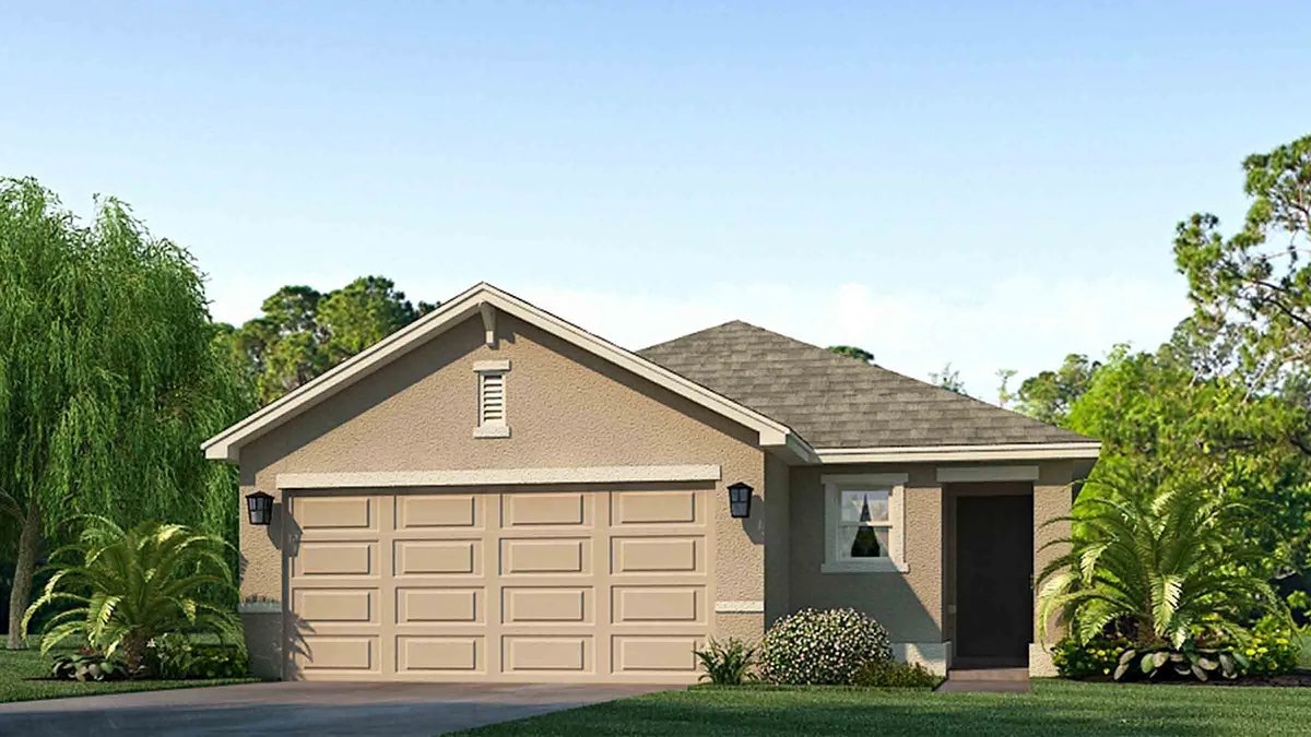 Single-story beige house with a gray shingle roof, two-car garage, and a small front yard with green grass, shrubs, and palm trees. Blue sky and trees are visible in the background.