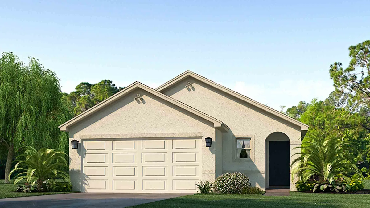 A single-story, light-colored house with a double garage, two front-facing gables, black lantern-style lights, an arched doorway, and neatly landscaped greenery in front, set against a clear blue sky.