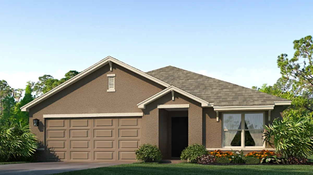 Single-story suburban house with a gray roof, brown exterior, double garage, and front yard landscaping with bushes and flowers. Large window on the right side and a clear blue sky in the background.