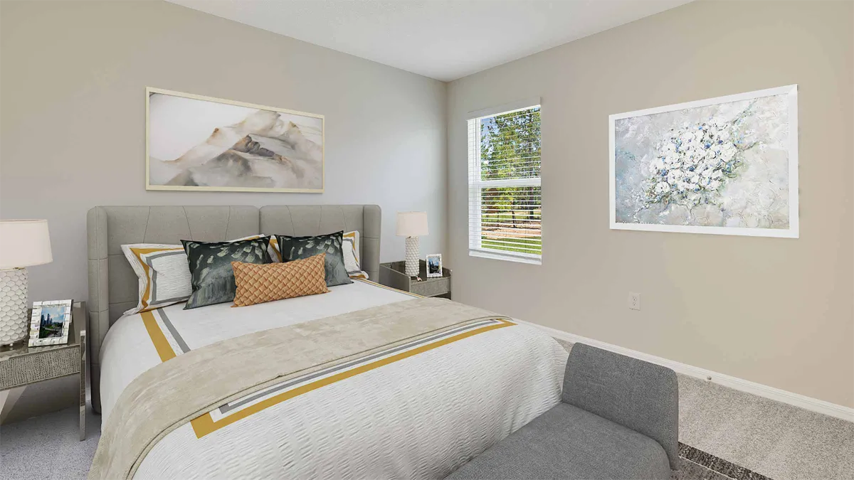 A bright, modern bedroom with a neatly made bed, two bedside tables with lamps and framed photos, abstract artwork on the walls, a window letting in sunlight, and a small upholstered bench at the foot of the bed.