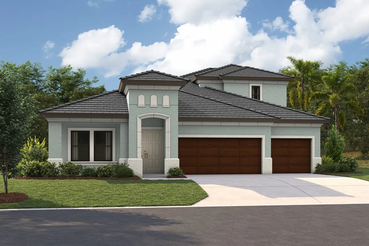 A modern, two-story house with light gray stucco exterior, dark gray roof tiles, and three brown garage doors, surrounded by green lawn, trees, and blue sky with clouds.