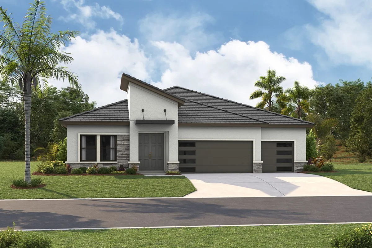 Modern single-story house with gray roof, large double garage, stone and stucco exterior, front lawn, palm trees, and a driveway, set against a partly cloudy sky and lush green surroundings.