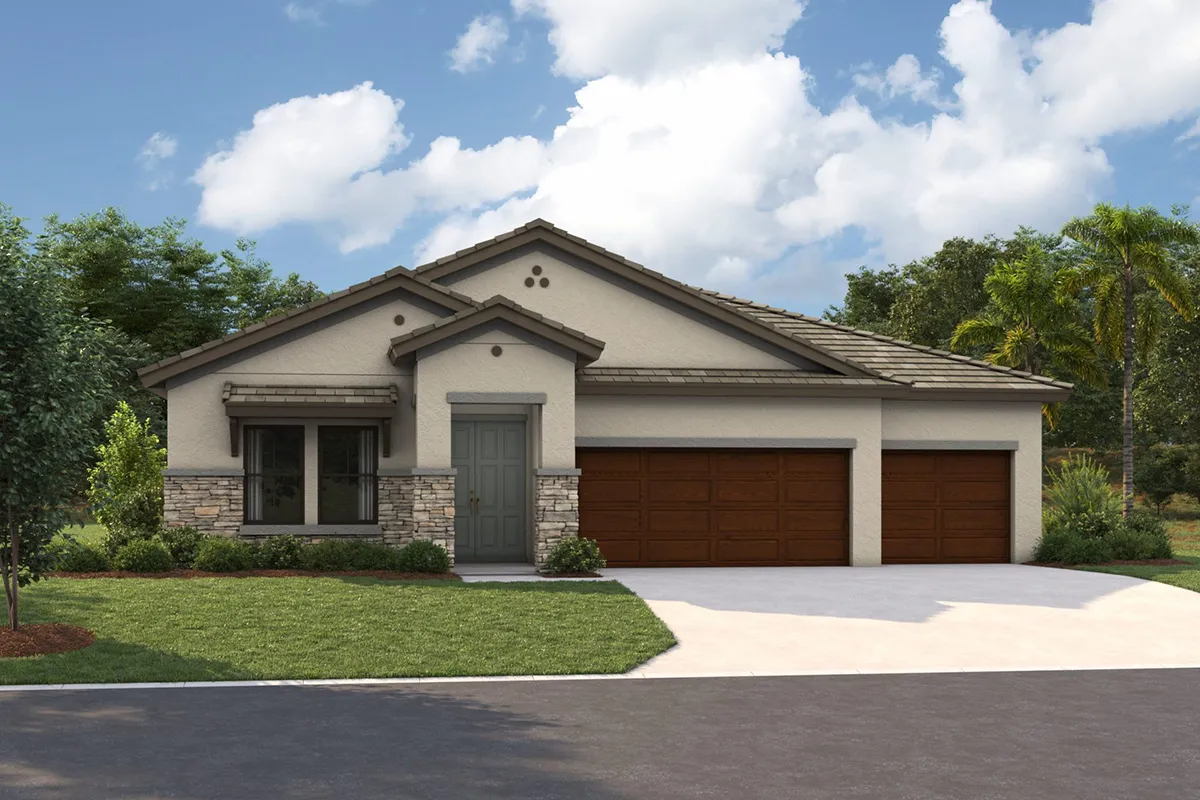 Single-story modern house with a light beige exterior, stone accents, a gray front door, and three wooden garage doors. The front yard has green grass, small shrubs, and a tree, with a clear blue sky above.