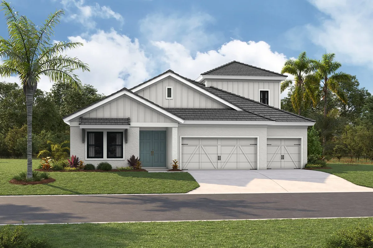 A modern white house with gray accents, a large garage, blue front doors, and a manicured lawn, set against a backdrop of trees and a partly cloudy sky.