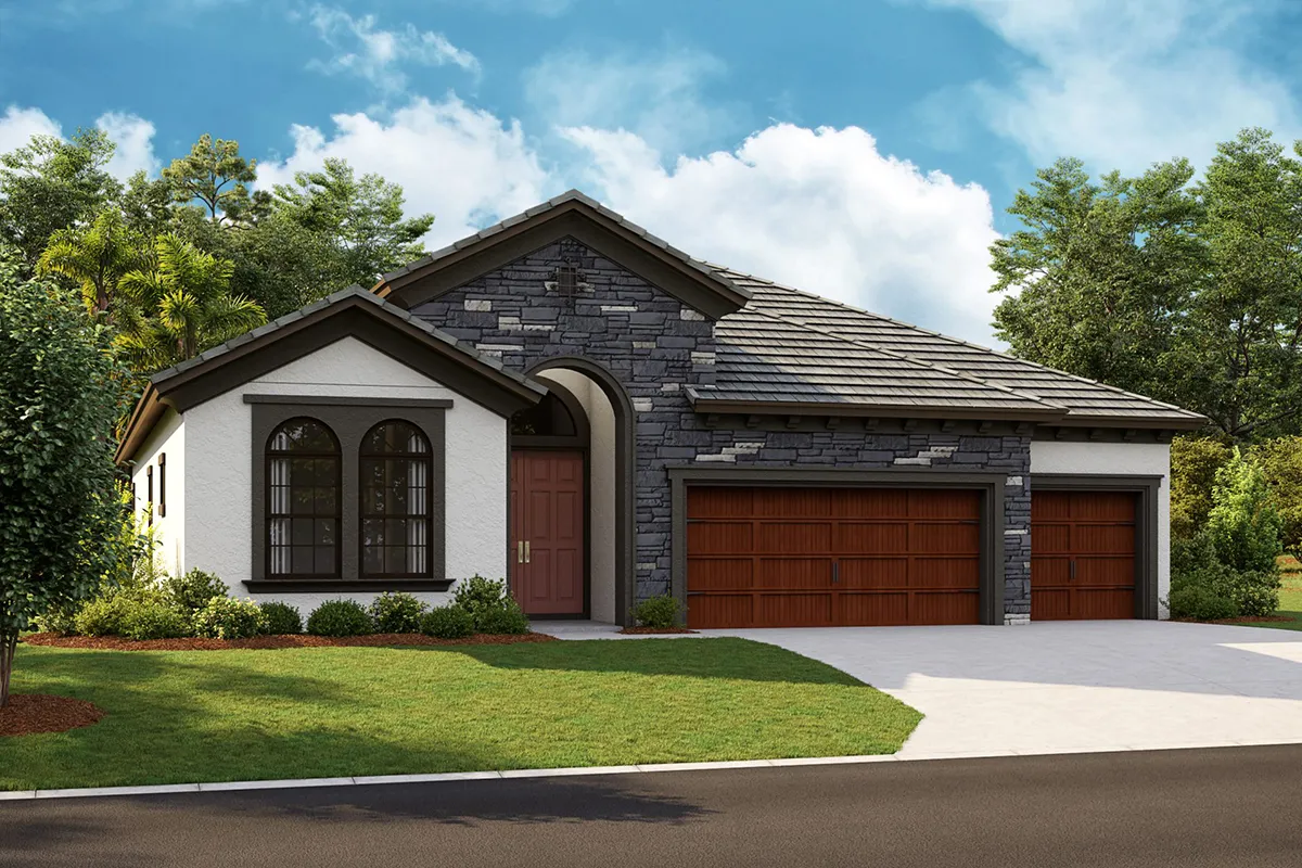 A modern single-story house with a mix of stone and stucco exterior, large arched windows, a red double front door, and a three-car wooden garage, surrounded by green grass and trees under a blue sky.