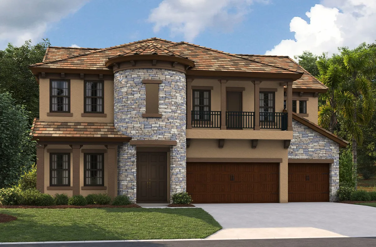 Two-story house with tan stucco and stone exterior, featuring a round turret, dark trim, three-car garage with wooden doors, balcony above the garage, and landscaped front yard with shrubs and green trees in the background.
