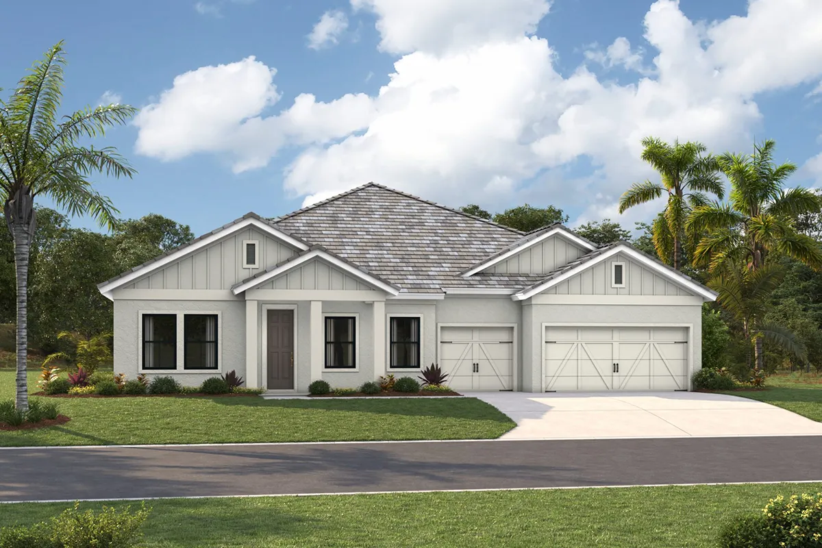 A modern, single-story white house with a gray shingle roof, two garages, and a neatly landscaped front yard with palm trees, set against a blue sky with scattered clouds.