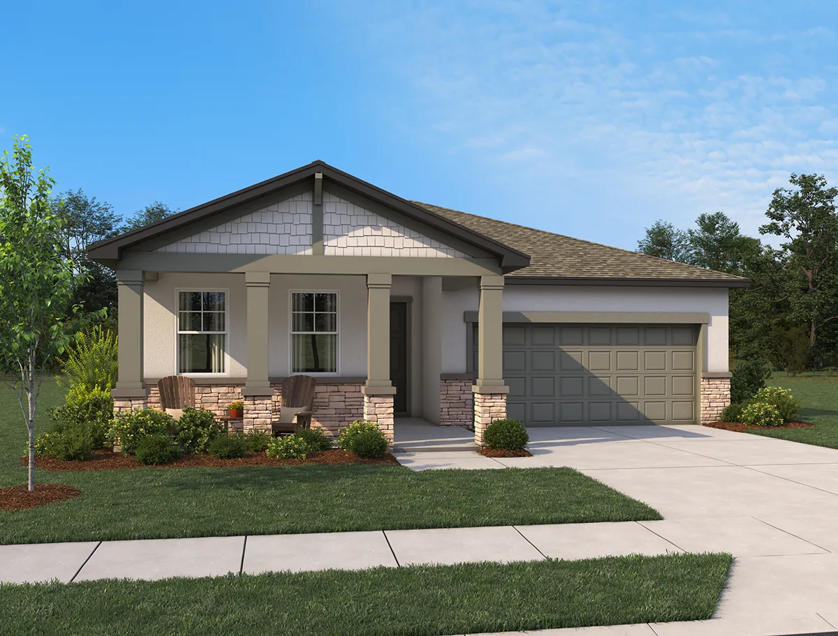 Single-story suburban house with a front porch, two chairs, a double garage, light-colored walls, stone accents, a well-kept lawn, shrubs, and a tree, set against a blue sky with a few clouds.