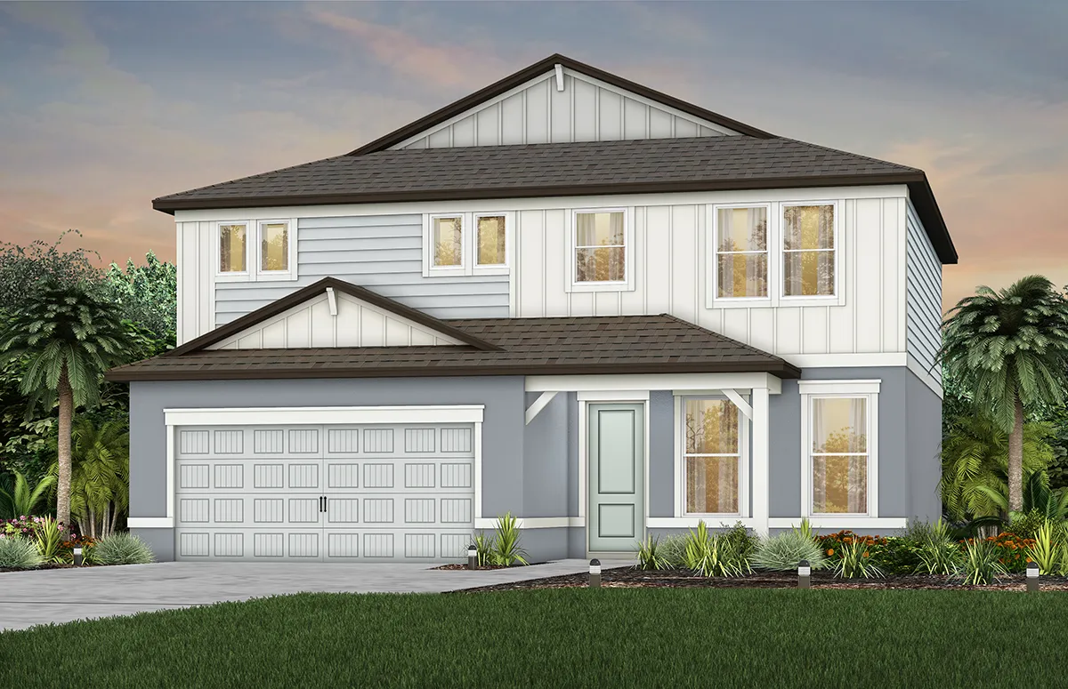 A modern two-story house with gray siding, white trim, a double garage, a front porch, and a well-maintained lawn with small shrubs and palm trees in the background under a cloudy sky.