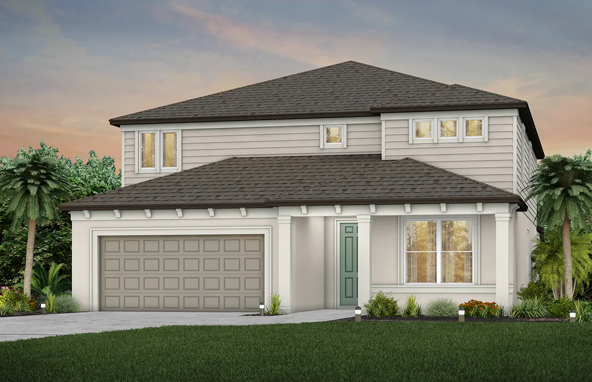 A modern two-story house with gray siding, a dark shingled roof, a double garage, a green front door, large windows, and landscaped greenery in front, set against a sunset sky.